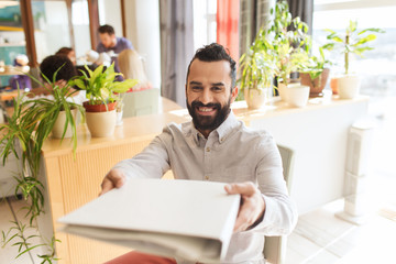 happy creative male office worker with folfer