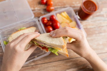 close up of woman with food in plastic container