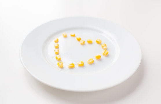close up of plate with corn in heart shape