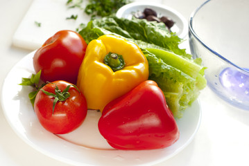 raw vegetables for salad on white plate