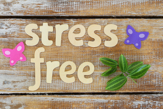Stress free written with wooden letters on rustic surface