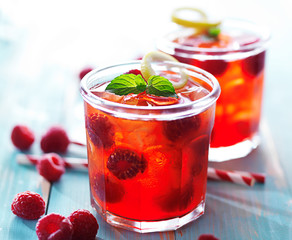 back lit glasses of raspberry juice cocktail with mint and lemon