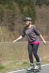 Active middle aged woman on inline skates