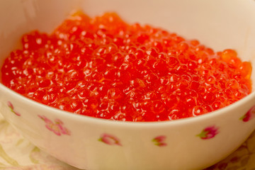 Red caviar in white bowl