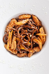 Italian pasta with sauce and parmesan cheese, served on a white 