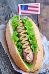 hotdog sandwich with yellow mustard sauce and lettuce