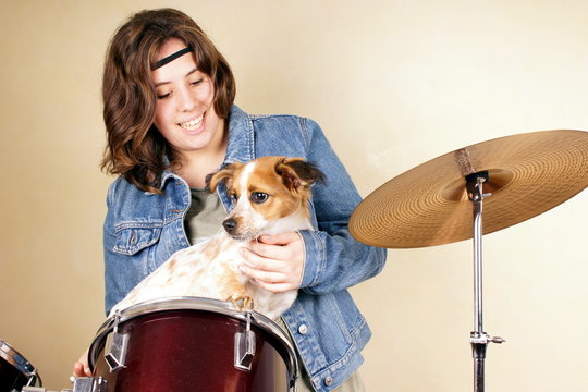 Studio Shot Of A Young Lady Holding A Little Dog