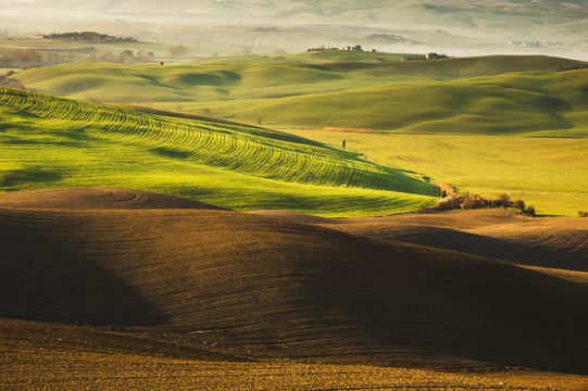 Beautiful Tuscan landscape with long shadows and mists © Jarek Pawlak