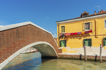 Colorful house and bridge in Murano island, Venice, Italy.