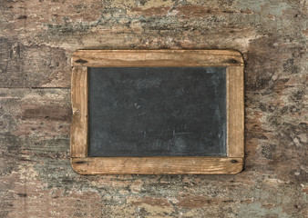 Antique blackboard on wooden texture. Nostalgic background