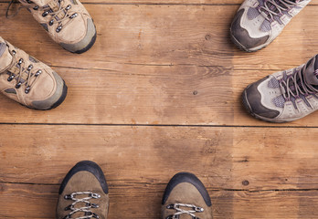 Hiking shoes laid on a wooden floor background