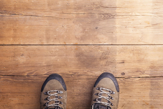 Hiking shoes laid on a wooden floor background