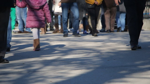 Legs of people on the city street
