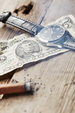 Dollar, clock and cigar
