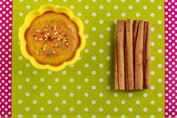 Cinnamon cupcake on a green cutting board