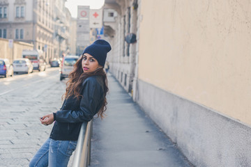 Fototapeta premium Beautiful girl posing in an urban context