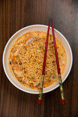 Instant noodles in dish on wood