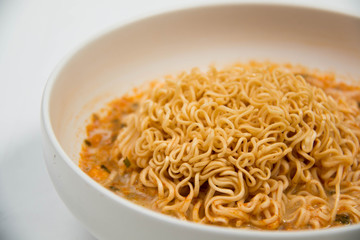 Instant noodles in dish on white