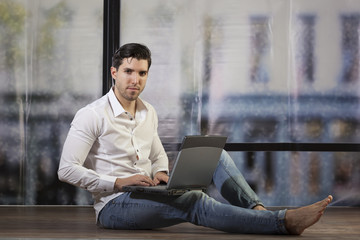 casual young man working on notebook 