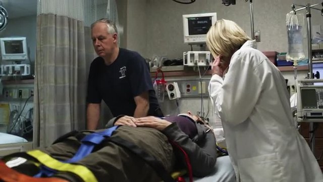 MS Paramedics placing patient on hospital bed / Payson, Utah, USA