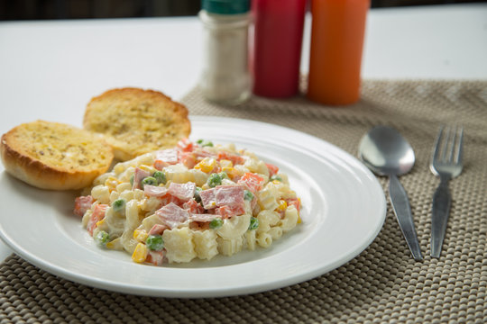 Macaroni salad with mayonnaise and vegetables.