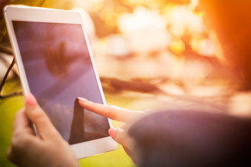 Girl using tablet or ebook outdoor closeup screen