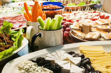 Home table with variety of appetizer dishes at party