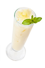 Cocktail Pina Colada  in a tall glass garnished mint leaf. Isola