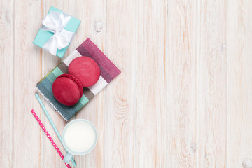 Obraz na płótnie Canvas Colorful macarons, cup of milk and gift box