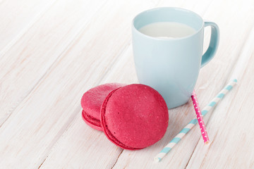 Colorful macarons and cup of milk