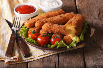 fried cheese and tomato sauce on a plate. Horizontal close-up