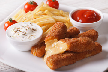 fried cheese and fries with sauce close-up, horizontal