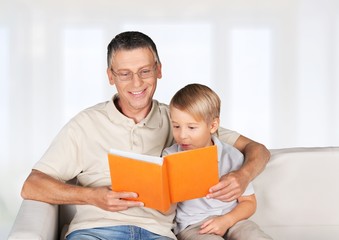 Grandchild. Grandmother and little boy reading book happy