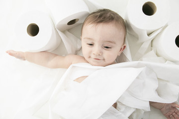 Toddler ripping up toilet paper in bathroom studio