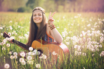 Smiling hippie woman giving peace sign