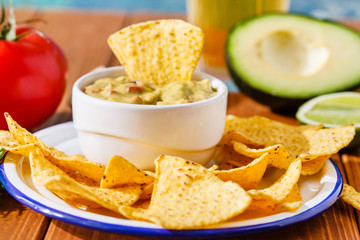 Guacamole with avocado, lime, tomato, and cilantro