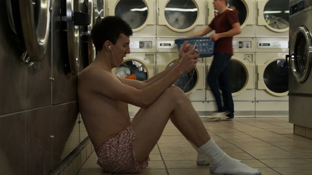 man in underwear at laundromat