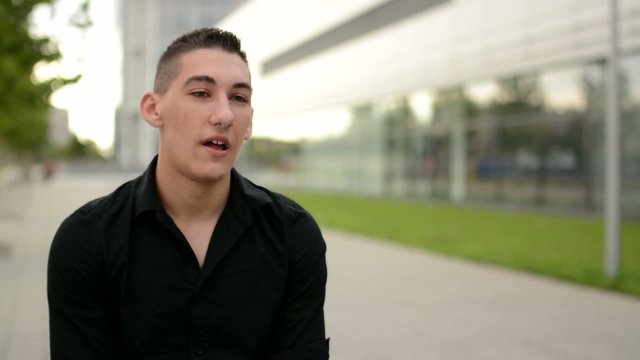 Young Man Talks To Camera (interview) - Street In The City