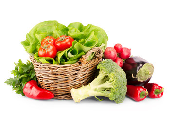 Full basket of ripe vegetables on white background