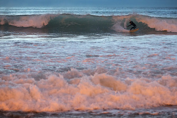 surfer in the sea at dusk in Orzan beach Corunna Spain
