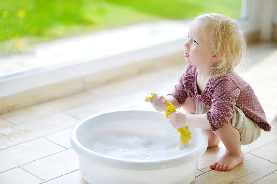 Little Toddler Girl Helping Her Mom To Clean Up