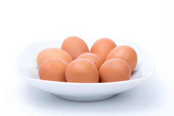 Eggs in dish on white background