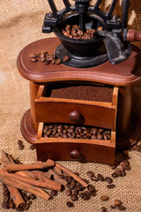 coffee beans, ground coffee, cinnamon, old wooden coffee grinder