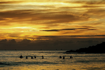 surfers at sunset in Doninhos beach Galicia