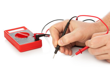 Hands and electric multimeter