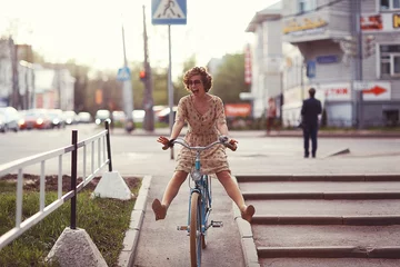 Foto op Plexiglas cheerful girl on a bicycle movement © kichigin19