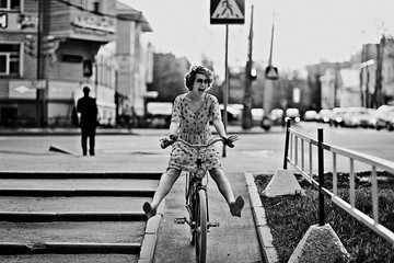 cheerful girl on a bicycle movement - obrazy, fototapety, plakaty