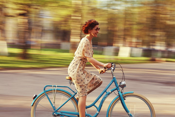 cheerful girl on a bicycle movement