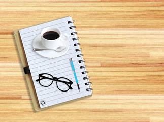 Notebook with office supplies with pen with glasses and cup of c