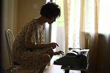 girl typing on a typewriter